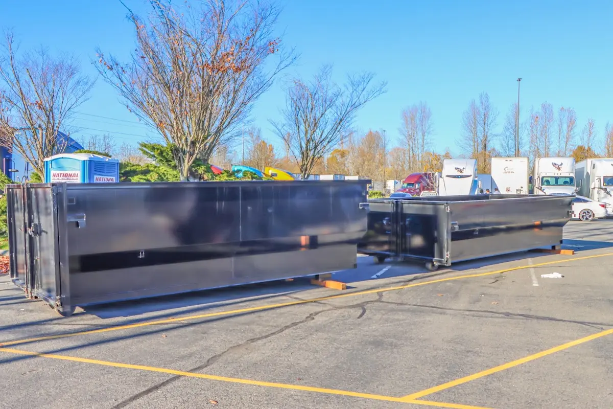 Professional dumpster rental service with roll-off container on residential driveway in American Fork